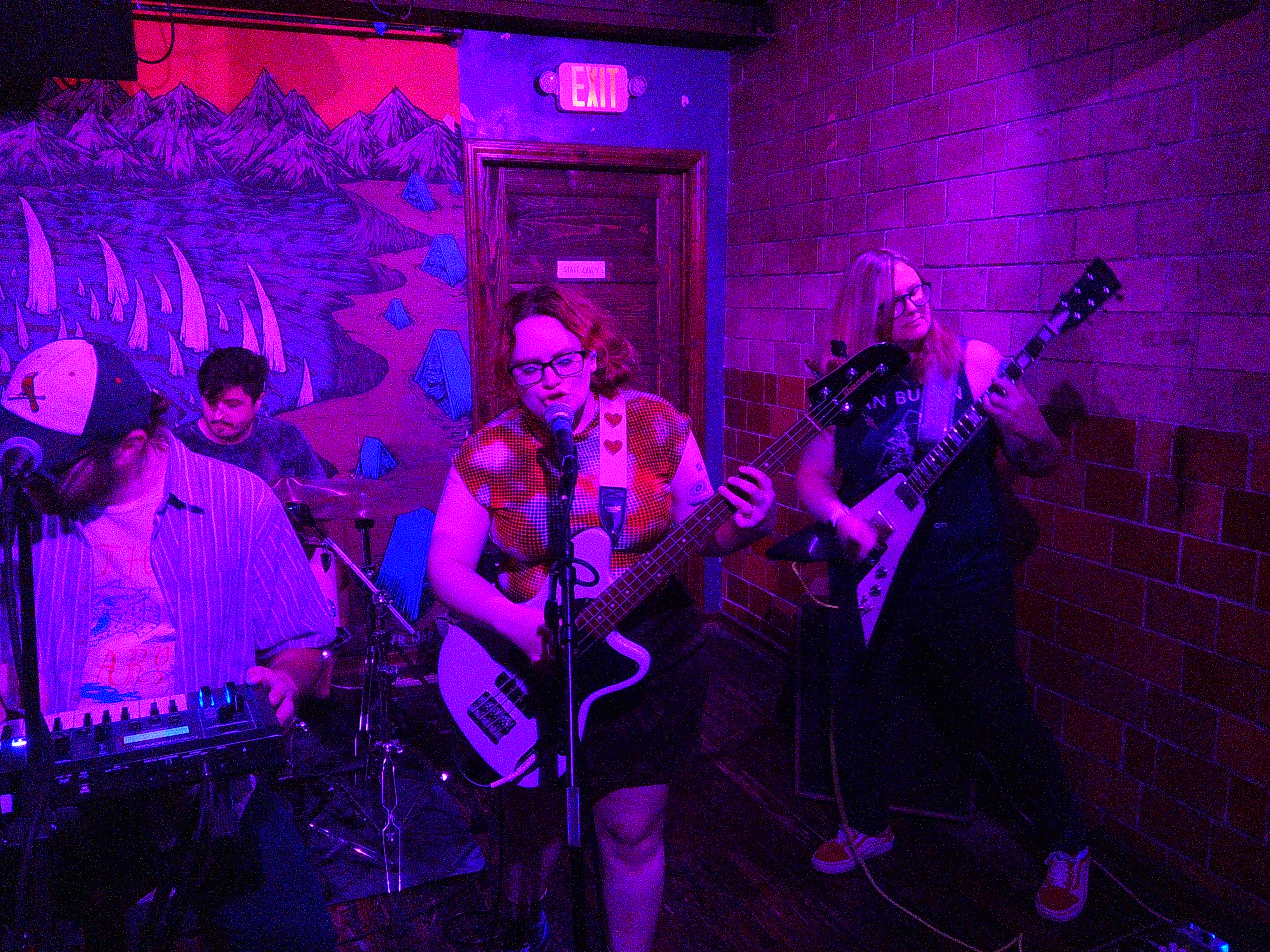 Adam playing drums, Ray playing keys, Haley playing bass and singing, and Lindsay playing guitar