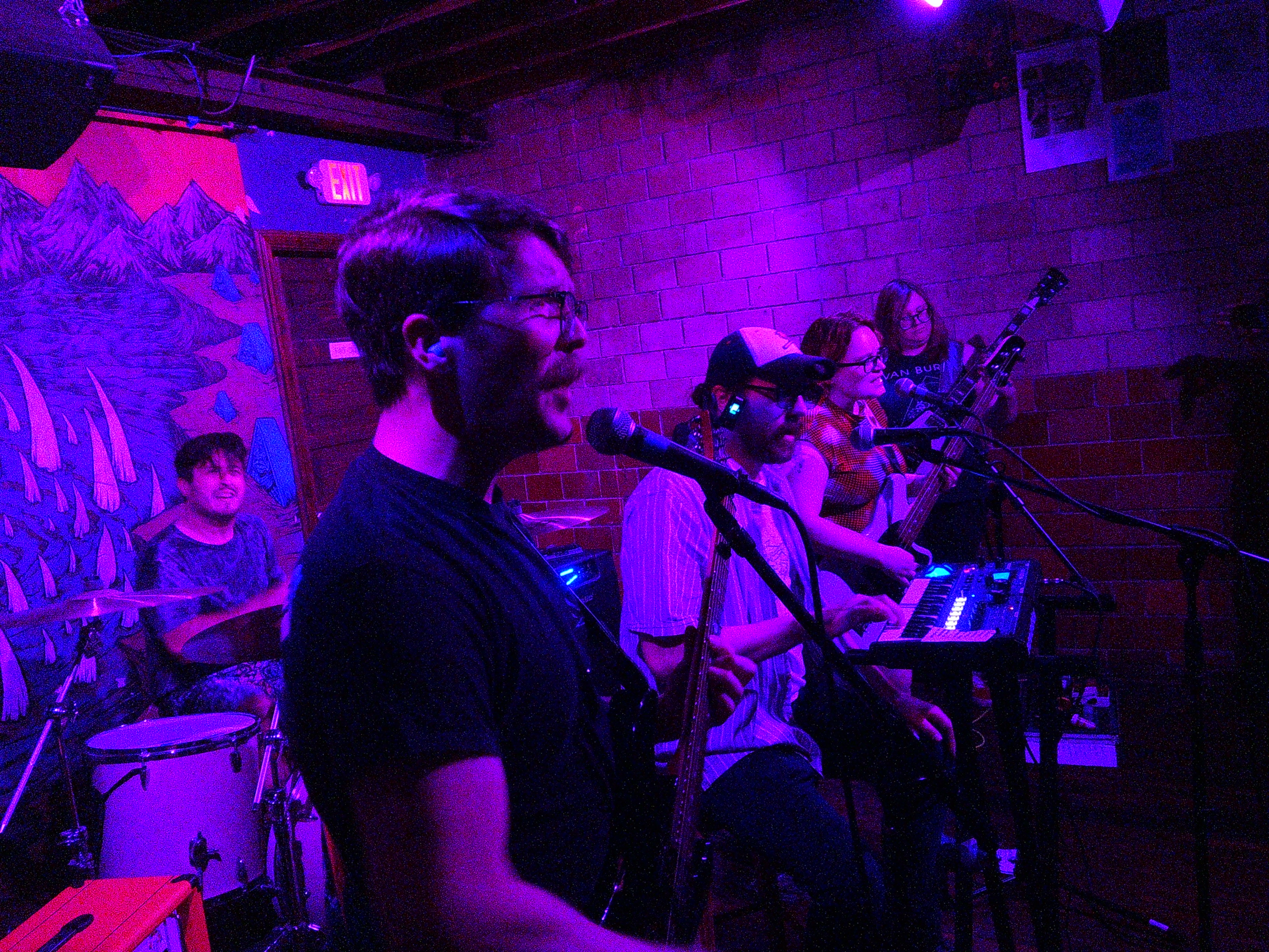 Adam playing drums, David playing guitar and singing, Ray playing keys,  Haley playing guitar, and Lindsay playing guitar